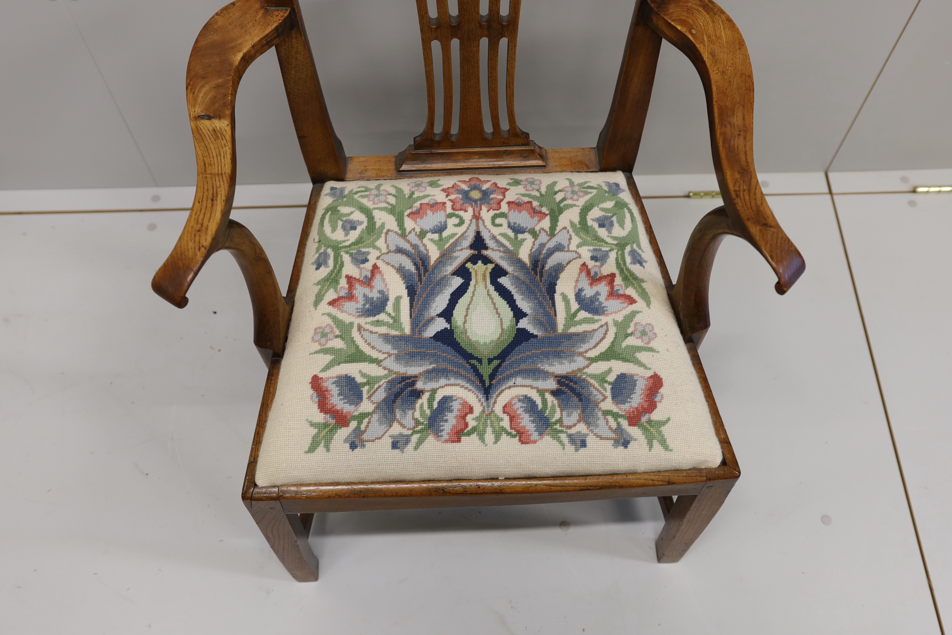 A George III provincial elm elbow chair, width 58cm, depth 45cm, height 94cm